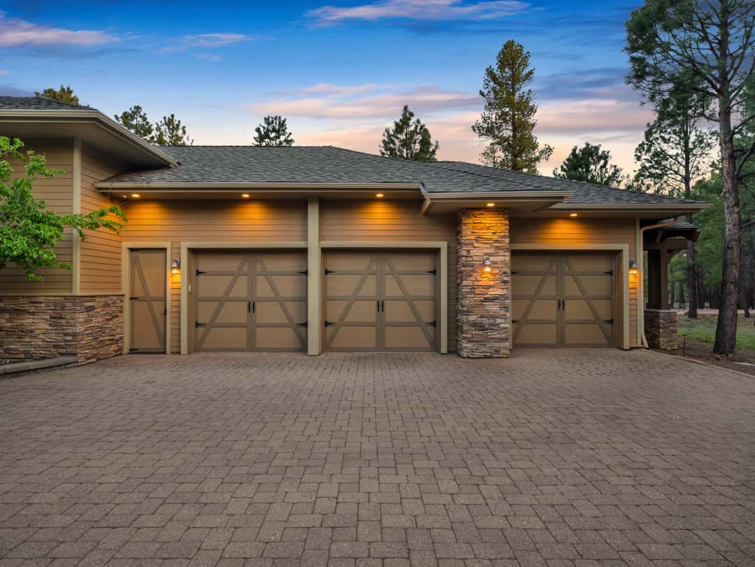 5 of 52. Custom temperature-controlled garage with room for five vehicles, golf cart storage, workshop space, and high-end convenience features throughout.
