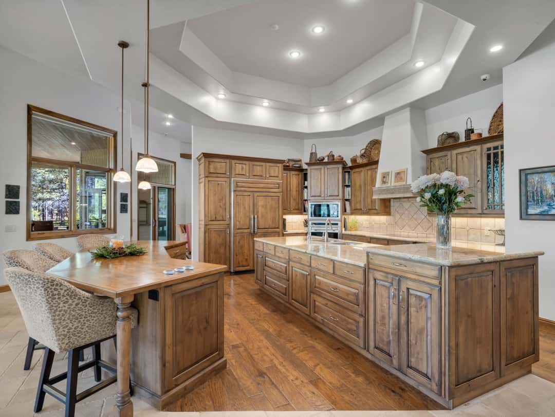 8 of 52. Stunning chef s kitchen with double islands, premium finishes, custom cabinetry, and spacious open-concept design perfect for entertaining and daily living.