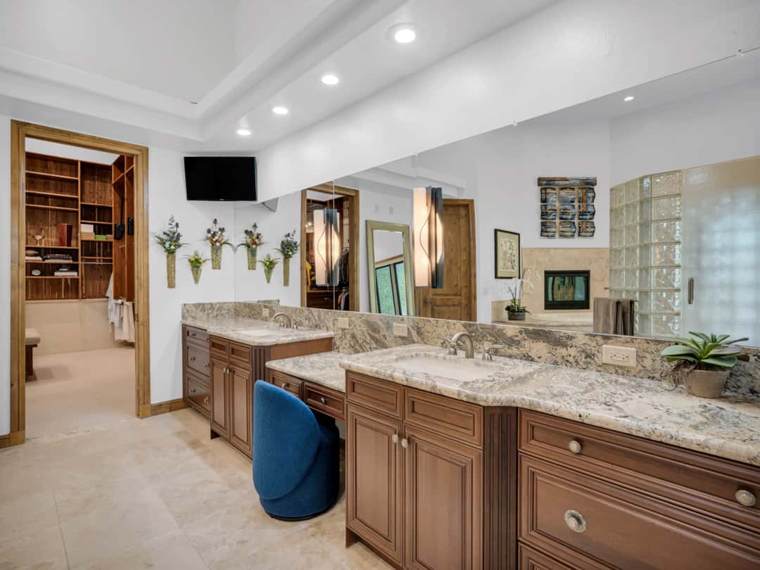 19 of 52. Elegant spa-inspired bathroom with dual sinks, custom cabinetry, granite countertops, designer lighting, and luxurious mountain-modern finishes throughout.