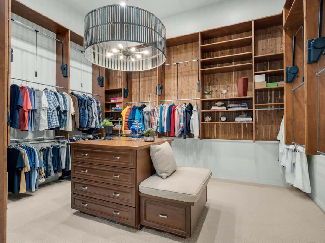23 of 52. Expansive custom closet with built-in shelving, center storage island, designer lighting, and boutique-inspired organization designed for upscale everyday living.