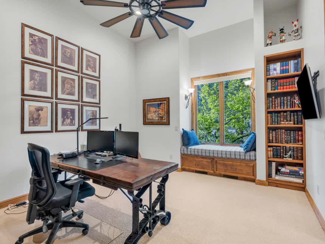 27 of 52. Spacious bedroom with built-in window bench seating, custom shelving, tall ceilings, and beautiful natural light throughout the inviting living space.