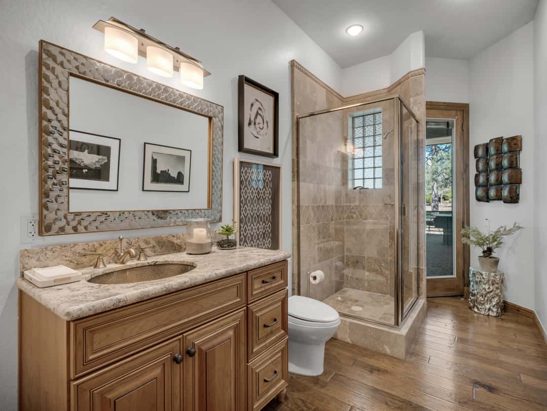 31 of 52. Upscale guest bath featuring tiled walk-in shower, granite countertops, custom vanity cabinetry, and elegant lighting for a refined luxury feel.