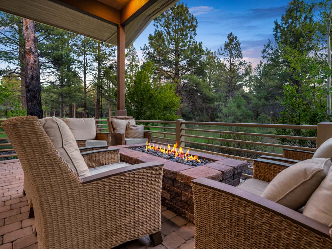 33 of 52. Cozy outdoor firepit gathering area overlooking multiple golf course fairways, perfect for entertaining or relaxing beneath the Flagstaff evening skies.