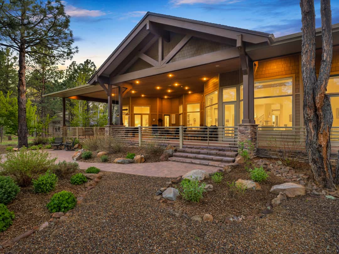 37 of 52. Gorgeous custom home exterior with timber beam accents, expansive covered patio areas, and beautifully landscaped grounds in the heart of Flagstaff.