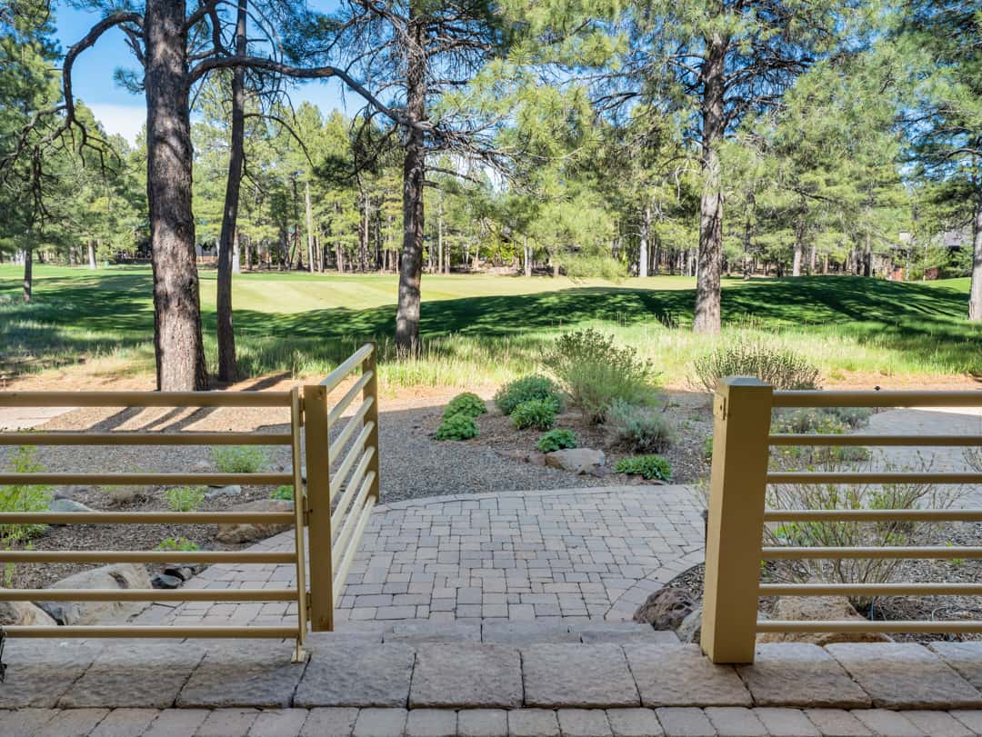 40 of 52. Charming backyard entrance opening to expansive fairway views, landscaped grounds, and peaceful forest surroundings in Flagstaff.