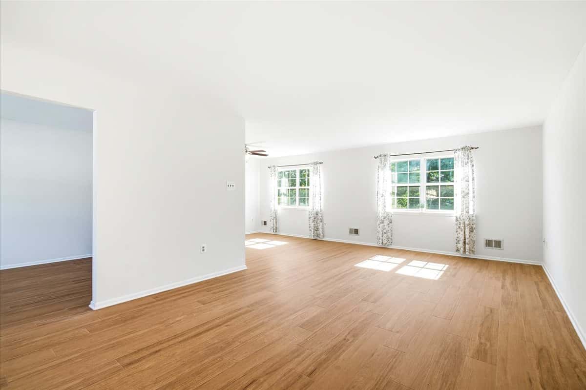 9 of 39. Spacious living area with abundant natural light, featuring large windows and a flexible layout for various uses.