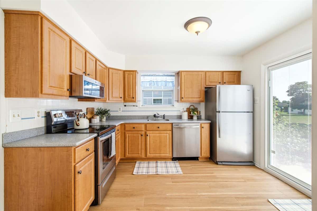 4 of 39. Bright, spacious kitchen featuring modern appliances, ample cabinetry, and an inviting layout perfect for entertaining.