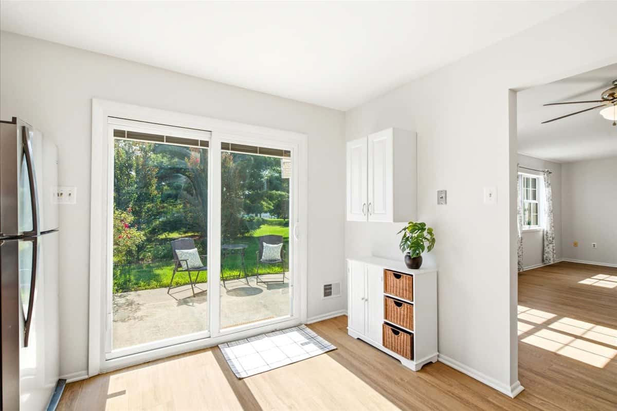 6 of 39. Bright and airy kitchen with sliding glass doors leading to a private outdoor space.