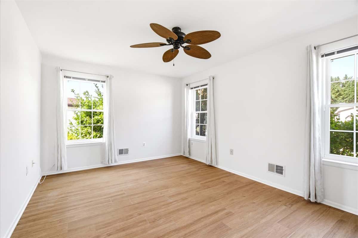 17 of 39. Bright, spacious room featuring large windows and a ceiling fan, perfect for personalizing to your taste.