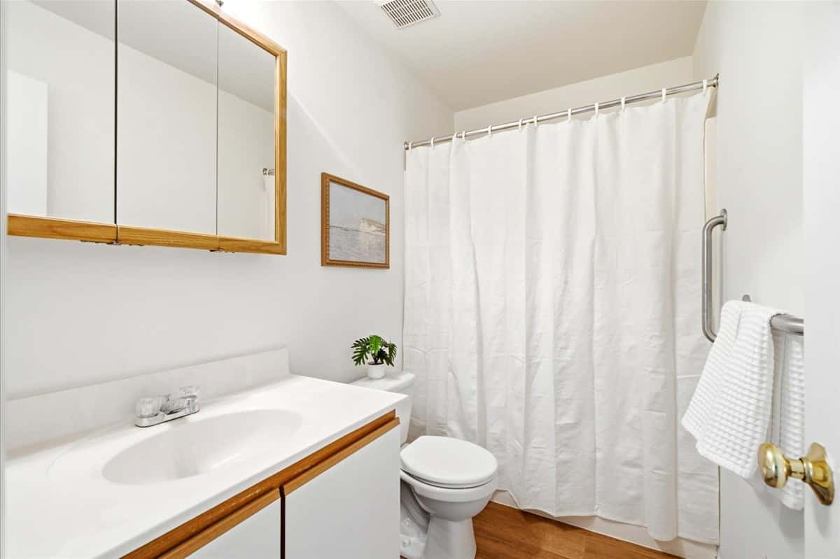 20 of 39. Well-maintained bathroom featuring a clean design with ample storage and natural light.