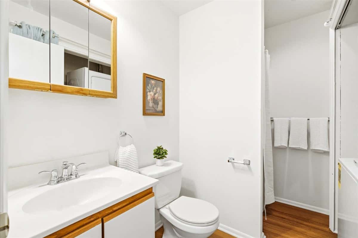 25 of 39. Bright and functional bathroom featuring modern fixtures, ample storage, and a warm, inviting atmosphere.