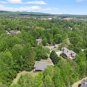Discover this expansive lot nestled among lush greenery, offering a peaceful retreat in a thriving community.