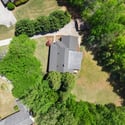 Spacious property surrounded by lush greenery, featuring ample outdoor space and convenient access to local amenities.