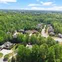 Sprawling community nestled among lush greenery, featuring modern homes and picturesque views throughout the neighborhood.