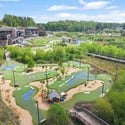 Discover this vibrant community featuring a unique landscape with a mini-golf course and lush greenery.