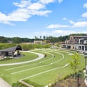 Expansive outdoor community space featuring a landscaped green area, perfect for gatherings and activities.