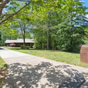 Spacious home set on a large lot, surrounded by lush greenery and ample outdoor space.