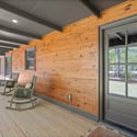 Discover this inviting porch with a natural wood finish, perfect for relaxing and enjoying outdoor moments.