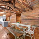 Spacious kitchen with exposed beams and natural wood finishes, perfect for family gatherings and entertaining.