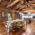 Bright, open kitchen and dining area feature rustic wood finishes, seamlessly blending modern amenities with cozy design.