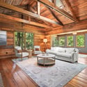 Warm wood finishes and abundant natural light create an inviting space, perfect for relaxation and gathering.