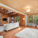 Bright, open living space featuring natural wood accents and large windows that invite the outdoors in.