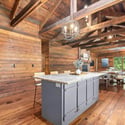 Rustic kitchen featuring a spacious island and rich wooden accents, perfect for gatherings and culinary creativity.