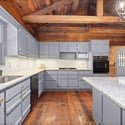 Discover this inviting kitchen featuring modern amenities, abundant natural light, and beautiful wood accents.
