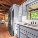 Bright and inviting kitchen with modern appliances, showcasing natural light and a seamless flow to the living area.