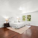 Bright and airy bedroom featuring a spacious layout, natural light, and easy access to outdoor views.