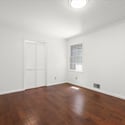 Bright and airy room featuring hardwood floors and ample natural light, perfect for various uses.