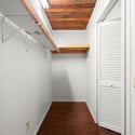 Spacious walk-in closet featuring ample storage and wooden accents, perfect for organizing your wardrobe.