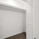 Spacious closet with ample storage space, featuring double doors and clean, modern finishes.