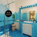 Bright and vibrant bathroom featuring unique blue tile work, modern fixtures, and natural light.