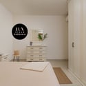 Bright bedroom featuring modern furnishings, ample storage, and a cozy atmosphere for relaxation.
