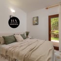 Cozy bedroom with natural light, featuring direct access to a private outdoor space.