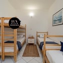 Cozy multi-bed room ideal for families, featuring natural light and convenient access to nearby amenities.