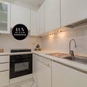 Modern kitchen featuring sleek cabinetry, ample counter space, and integrated appliances for efficient cooking.