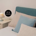 Cozy bedroom featuring a unique headboard, soft lighting, and a tranquil color palette for relaxation.