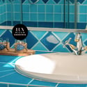 This vibrant bathroom features striking blue tiles and a practical layout, perfect for modern living.
