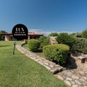 Lush gardens surround this inviting villa, featuring spacious outdoor areas and stunning views of the landscape.
