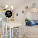 Bright and airy living space with a cozy dining area and modern kitchen, perfect for gatherings.