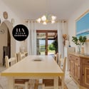 Bright and inviting dining space with scenic views, featuring a spacious table perfect for gatherings.