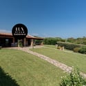 Discover this inviting villa in Sardinia, featuring expansive gardens and stunning outdoor spaces perfect for relaxation.