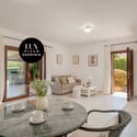 Bright and inviting living space featuring large doors that open to a lush outdoor area.
