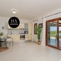Bright and open kitchen seamlessly connects to a spacious living area, perfect for entertaining and relaxation.