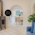 Bright and airy space featuring unique architectural arches and cozy wood stove for year-round comfort.