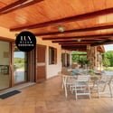 Spacious outdoor patio perfect for entertaining, surrounded by lush greenery and scenic views of Sardinia.
