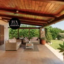 Spacious outdoor patio with lush greenery, perfect for relaxing and entertaining in a vibrant setting.