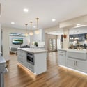 High-end kitchen showcasing dual islands, custom cabinetry, statement lighting, and premium finishes ideal for entertaining in Arcadia.